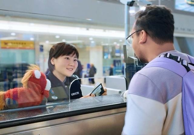 民警白丽丽为旅客办理边检手续。王艺璇 摄