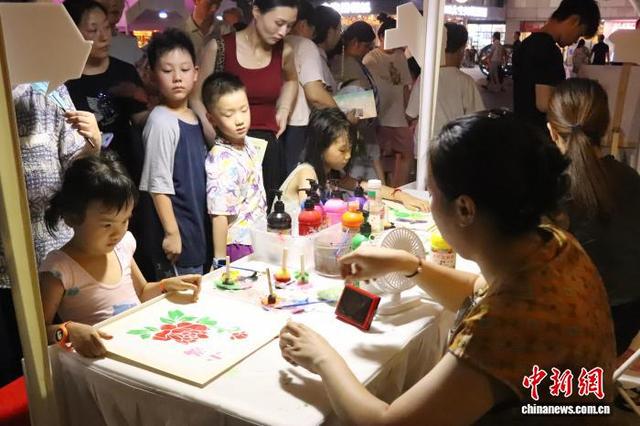 图为集市现场正在拓画的小朋友。 熊锦阳 摄