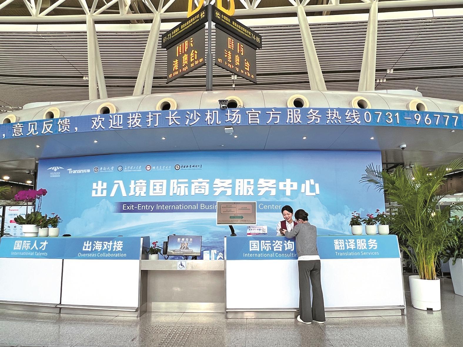 　　黄花机场出入境国际商务服务中心工作人员正在为旅客提供咨询服务 王宏 摄