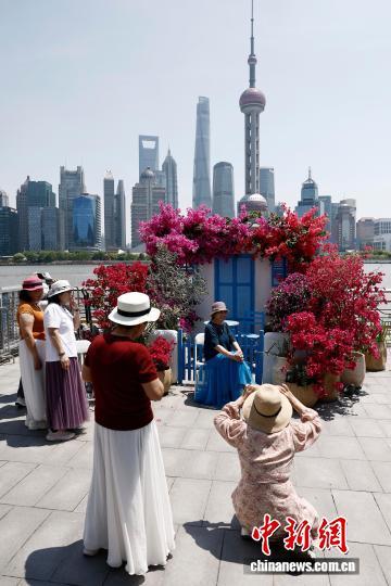 5月1日，游客在上海市虹口区北外滩滨江区域拍照，享受“五一”假期户外生活。中新社记者 殷立勤 摄